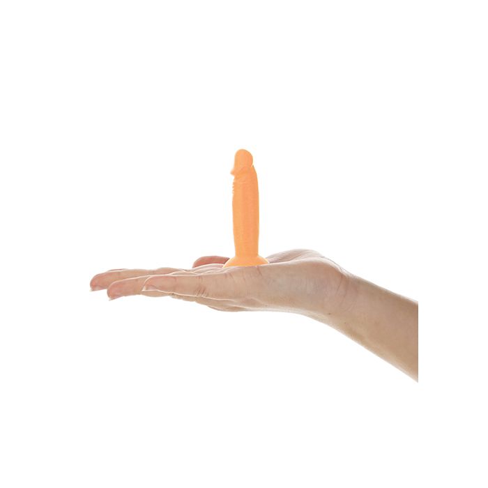 Addiction Silly Willy glowing in the dark, shown in a woman's hand to display size and measurements