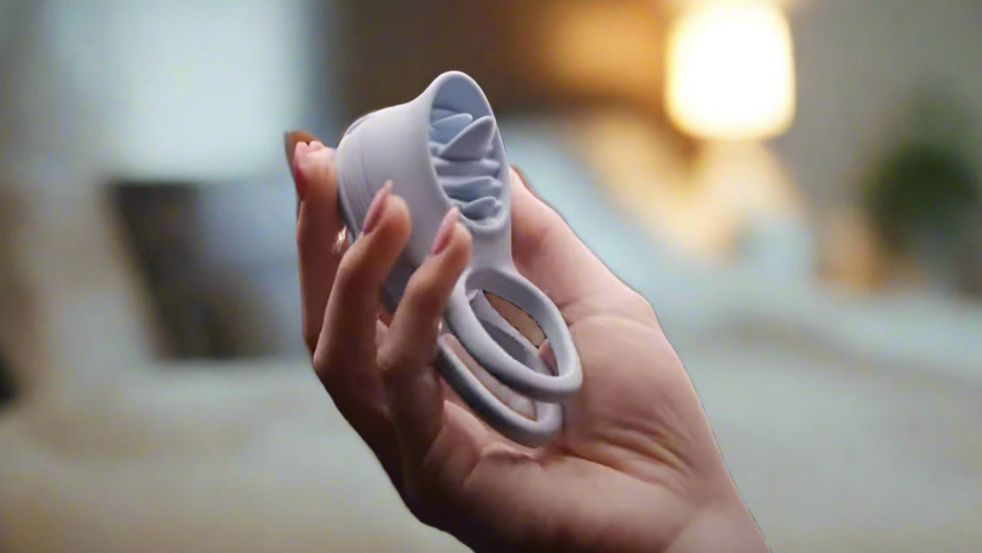 Pure Romance Made For Two couples toy in woman's hand in bedroom.