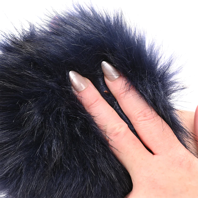 Close-up of a hand with a manicured nail touching black faux fur Sportsheets Cougar Spiked Glove.
