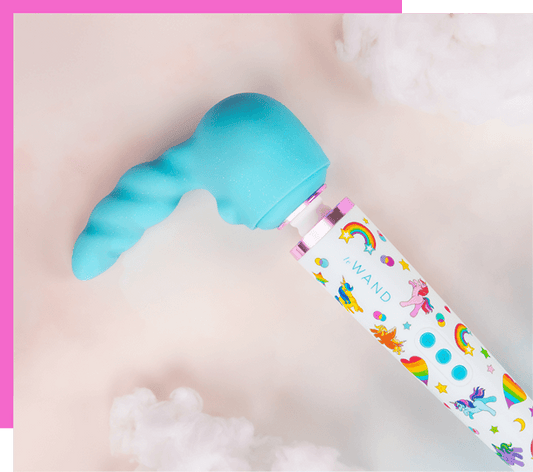 Le Wand Unicorn Wand Limited Edition Set wand vibrator with colorful packaging on a light pink background featuring the unicorn attachment