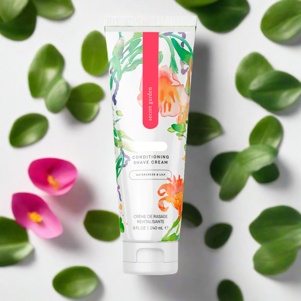 Rure Romance Coochy Conditioning Shave Cream in Secret Garden scent among leaves and flowers.