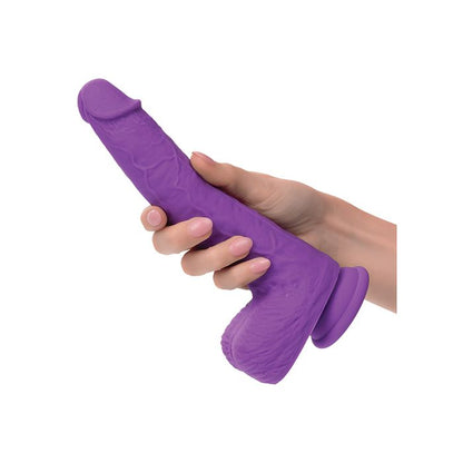 Calexotics Studs Purple silicone toy held by a hand on a white background
