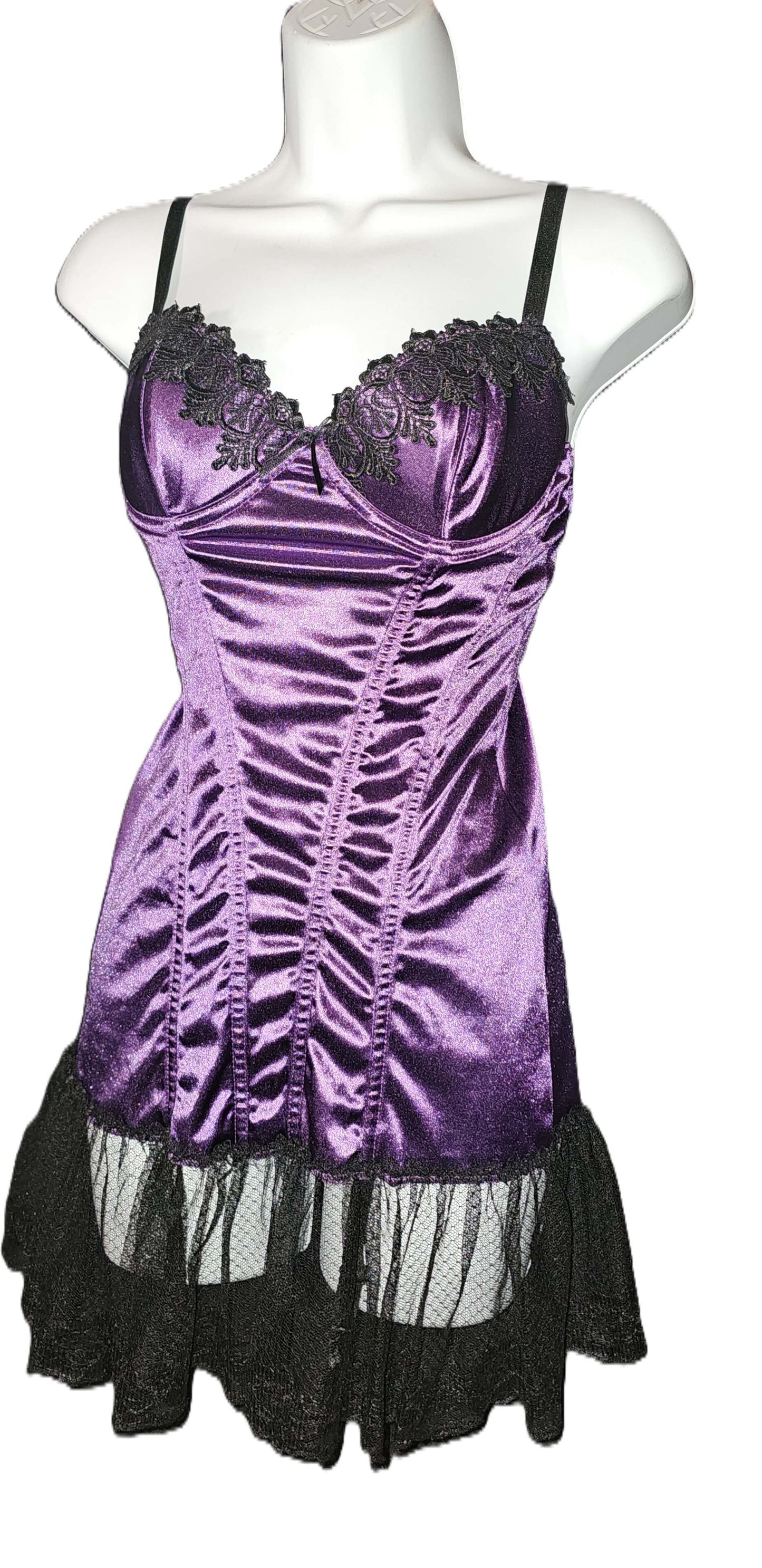 A purple satin corset-style babydoll dress with black lace trim and a black ruffled tulle hem, displayed on a white mannequin torso against a plain white background. Escante Luxury Lace Purple Babydoll Dress with Matching Thong - Medium