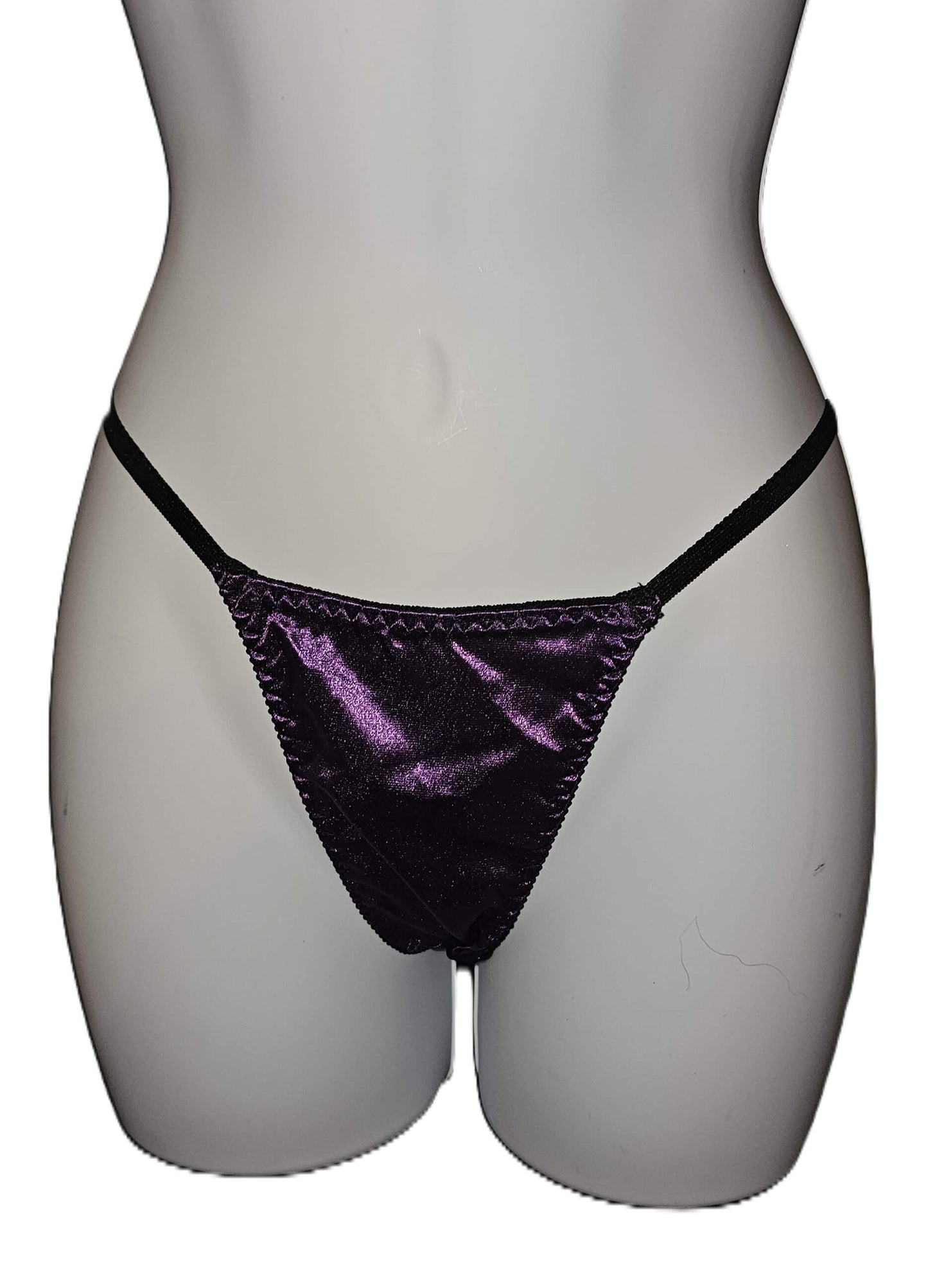 A pair of metallic purple thong panties with black elastic straps, displayed on a white mannequin torso against a white background. Escante Luxury Lace Purple Babydoll Dress with Matching Thong - Medium