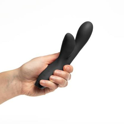 Black Je Joue Hera Flex Vibrator held in a hand against a white background
