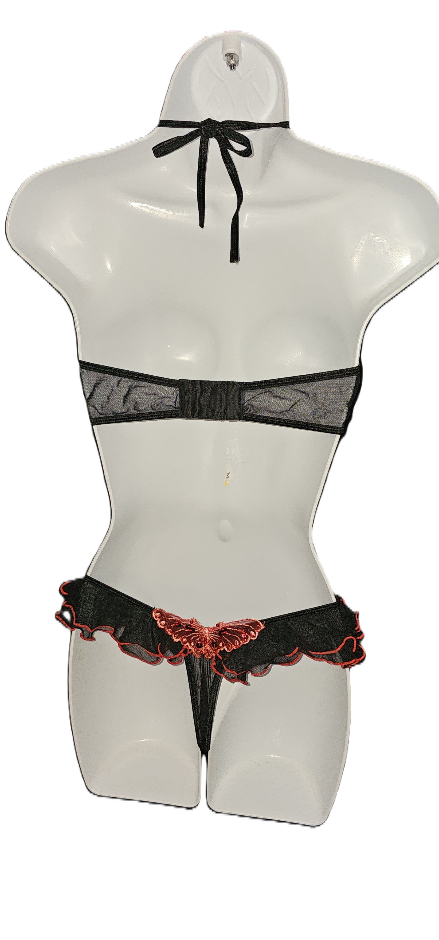 Black lace and mesh lingerie set with a butterfly applique, displayed on a white mannequin torso against a white background. Vintage Leg Avenue black halter bra top and ruffle thong lingerie set with red sequin butterfly accent