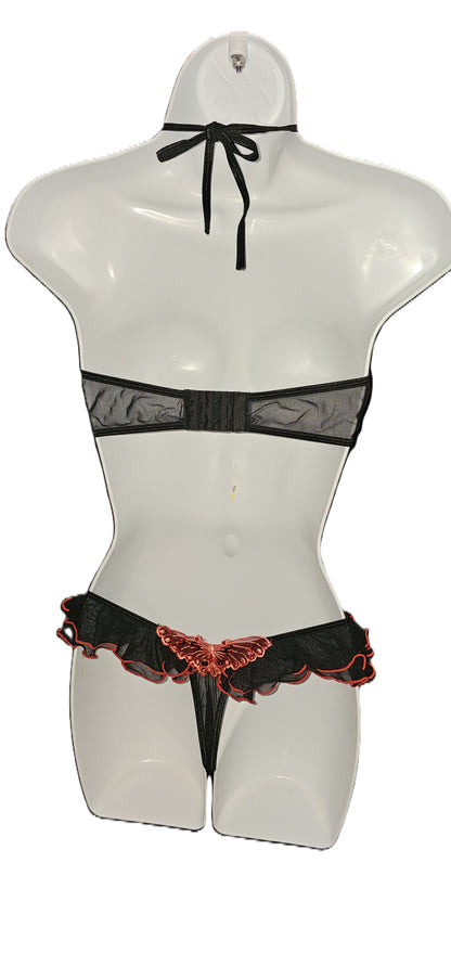 Black lace and mesh lingerie set with a butterfly applique, displayed on a white mannequin torso against a white background. Vintage Leg Avenue black halter bra top and ruffle thong lingerie set with red sequin butterfly accent