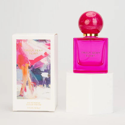 Pink Truly Sexy Flirt perfume bottle with colorful packaging on a white background