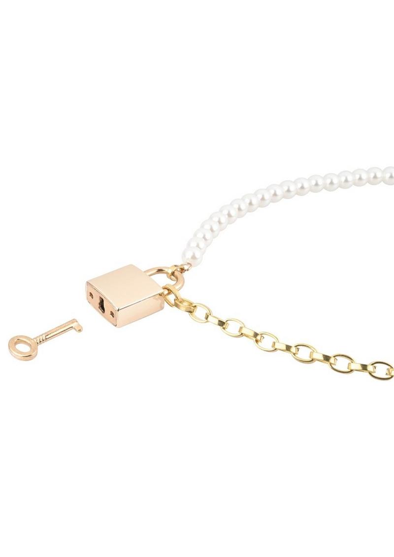 Gold and pearl necklace with a lock and key charm on a white background