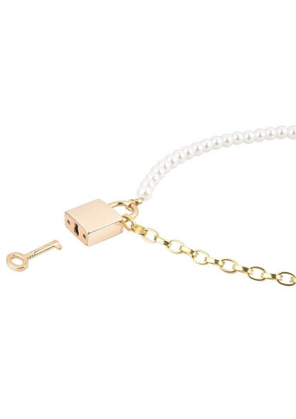 Gold and pearl necklace with a lock and key charm on a white background