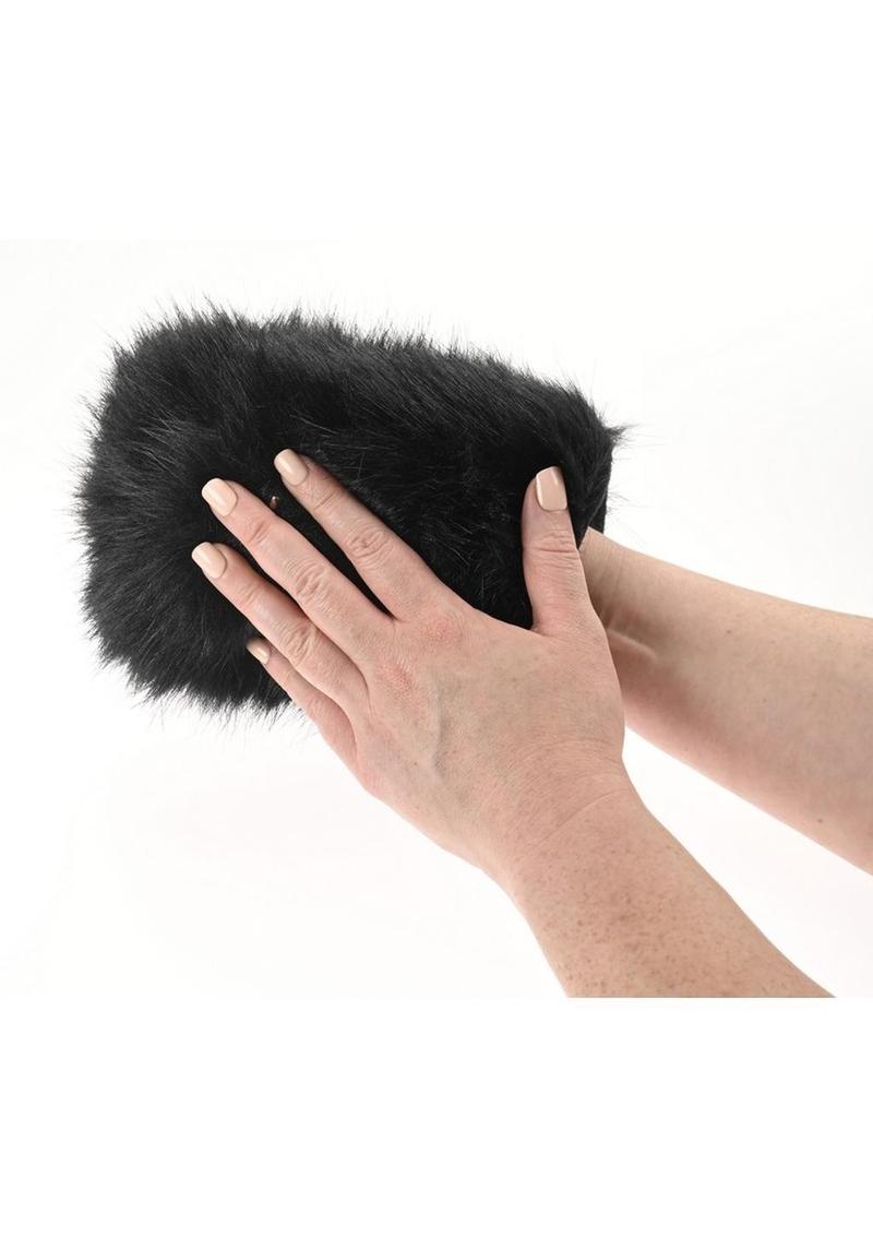 Black fur Sportsheets Spiked Sensory Mitt being held by a woman's hands on a whaite background