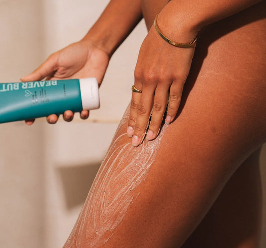 Person applying a Beaver Butter Cream Body Buffing Polish to their leg with a focus on the application process.