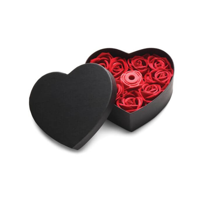 Heart-shaped black box with red roses  and rose vibrator on a white background