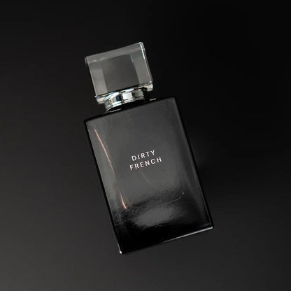 Black perfume bottle by Pure Romance  labeled 'Dirty French' on a black background