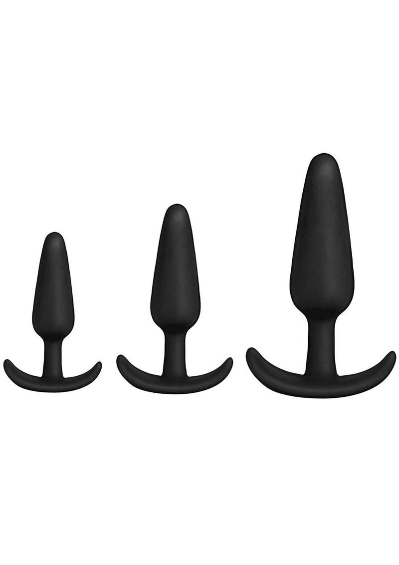 Three black silicone butt plugs by Doc Johnson in a Bag line, in three different sizes on a white background