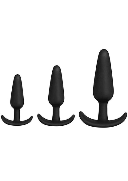 Three black silicone butt plugs by Doc Johnson in a Bag line, in three different sizes on a white background