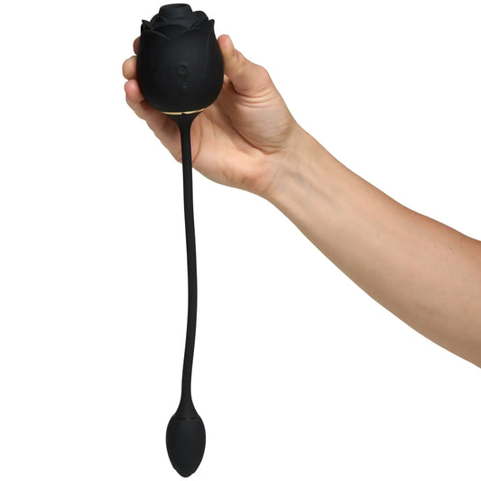 Hand holding Fifty Shades of Grey Dark Blushing Rose vibrator on a white background