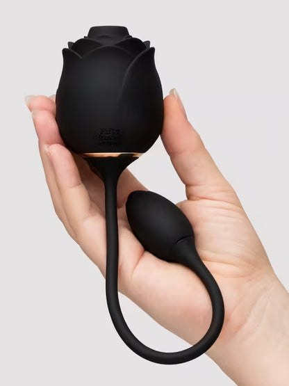Fifty Shades of Grey Dark Blushing Rose Vibrator held in a hand against a light gray background