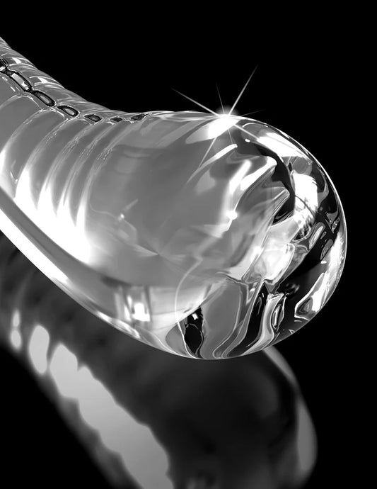 Close-up of Icicles No 88 clear glass dildo with reflections on a black background by Pipedream.