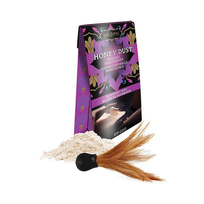 Kama Sutra Honey Dust Raspberry Kiss kissable body powder with packaging and a feather applicator on a white background