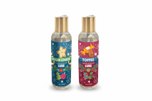 Two bottles of Little Genie Holiday Lubricant in 'Toffee' and 'Sugar Cookie'  with colorful labels on a white background.