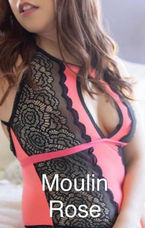 A close-up of a woman wearing a coral and black lace teddy lingerie from Texas Love Shop. The text 'Moulin Rose' is overlaid at the bottom.