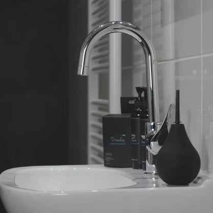 Bathroom sink with modern faucet and black toiletries featuring Nexus Anal Douche Non Return Valve 224ml sitting upright