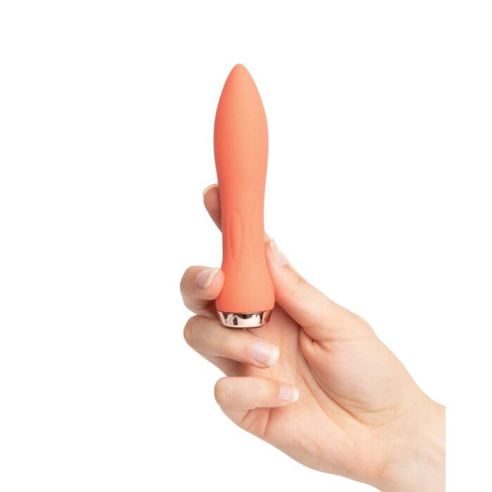 Coral Nu Sensuelle 60sx Amp Silicone Bullet in woman's hand for size reference