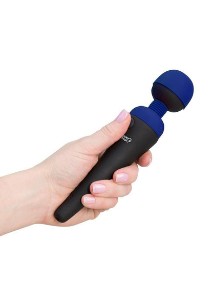 Hand holding a black and blue massage vibrator by PalmPower on a white background