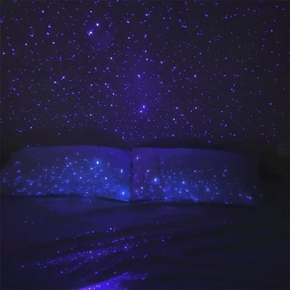 Svakom Pulse Galaxie clitoral air pulse technology stimulator with starlight projector video in a dark room projecting white stars on bed and wall