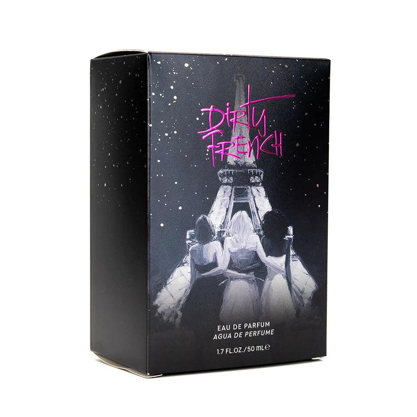Perfume box with 'Dirty French' branding and an image of three women sitting under the Eiffel Tower.