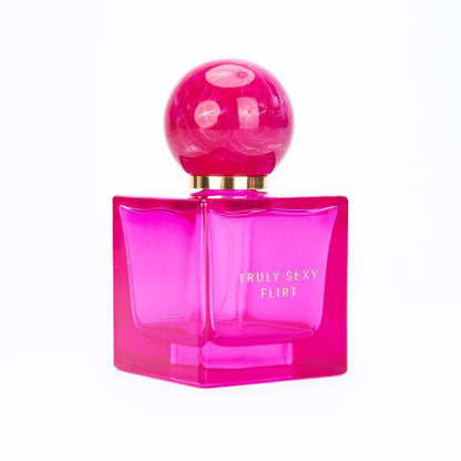 Pink perfume bottle labeled 'Truly Sexy Flirt' on a white background