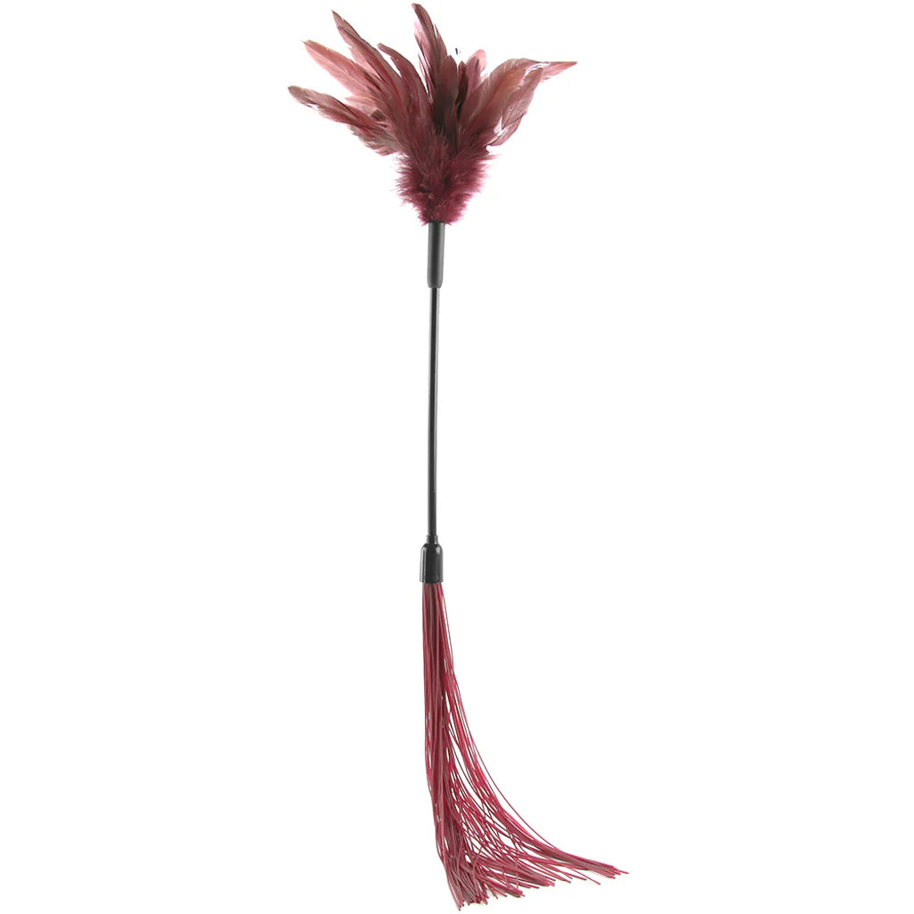 A decorative feather tickle whip with burgundy feathers on a black handle, featuring a matching burgundy silicone whip at the bottom, isolated on a white background.