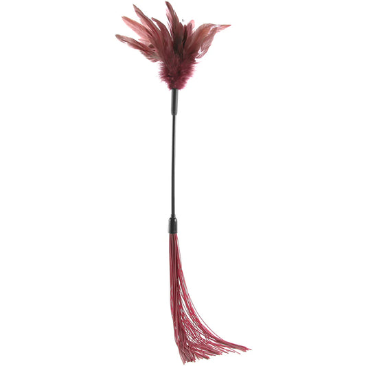 A decorative feather tickle whip with burgundy feathers on a black handle, featuring a matching burgundy silicone whip at the bottom, isolated on a white background.