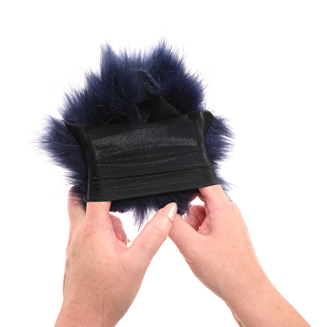 Black fur-lined product held by hands against a white background to show off Sportsheets Cougar Spiked Sensory Glove stretch.
