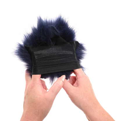 Black fur-lined product held by hands against a white background to show off Sportsheets Cougar Spiked Sensory Glove stretch.