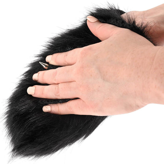 Black fur Sportsheets Spiked Sensory Mitt being touched by a woman's hands on a white background.