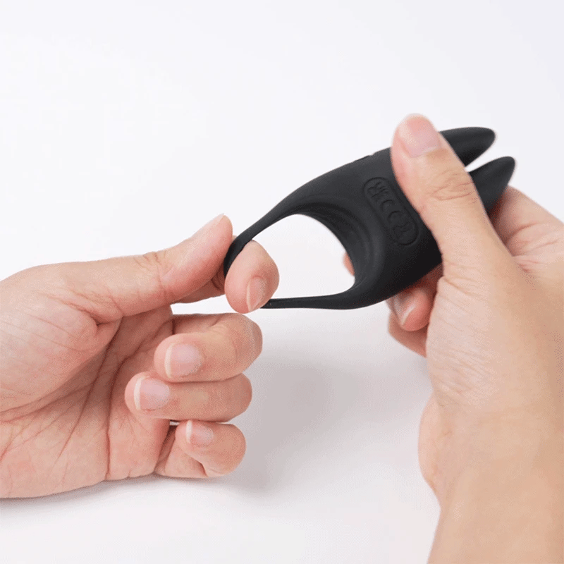 Svakom WINNI 2 Interactive Vibrating Rabbit Cock Ring with app control and remote control being stretched by two hands to show elasticity, on a white background