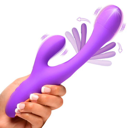 Woman holding the Inmi Tri-Flick Flicking Rabbit Vibrator by XR Brands in her hand, showing the compact size and ergonomic design.