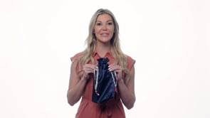 Pure Romance bioshield disinfecting silky navy blue disinfecting toy tote being held by woman to show size.