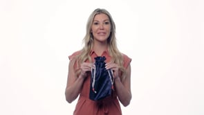 Pure Romance bioshield disinfecting silky navy blue disinfecting toy tote being held by woman to show size.